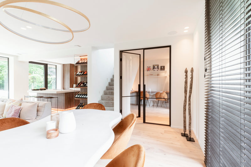 Modern interior design of a living room with a dining area and kitchen.