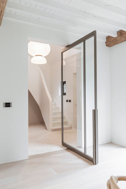 Modern interior with a glass door leading to a staircase