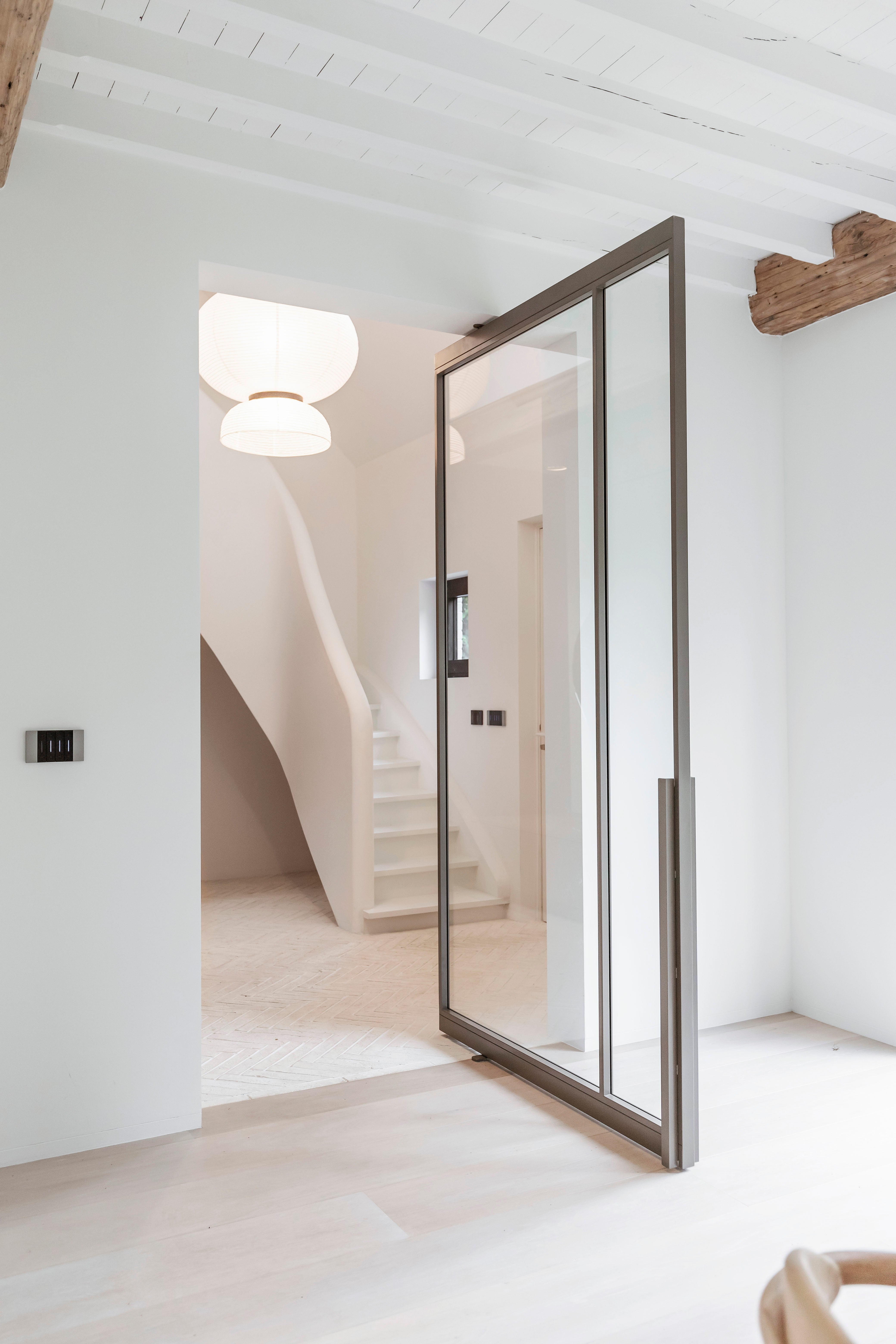 Modern interior with a glass door leading to a staircase